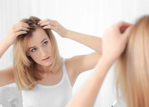 Woman checking for hair loss signs